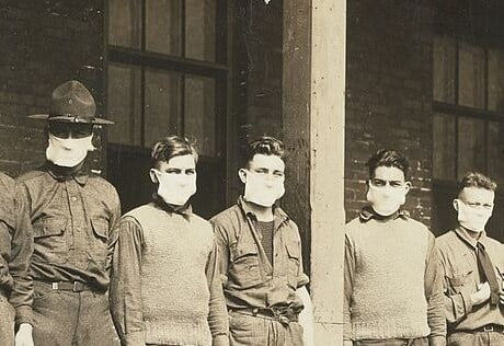 An old sepia photo. A line of soldiers. They are all wearing masks.