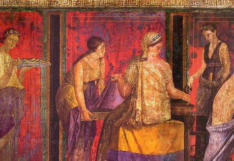 A long wall painting. There are many participants. Some play musical instruments, others carry trays, while others sit and watch the scene.
