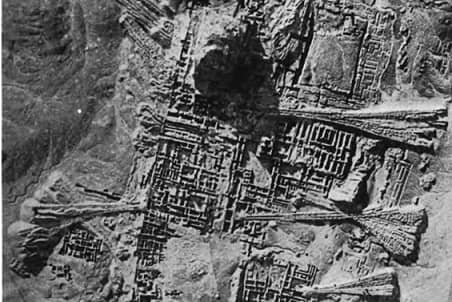 Picture taken from the air. It shows the layout of the city, with its walls and structures.