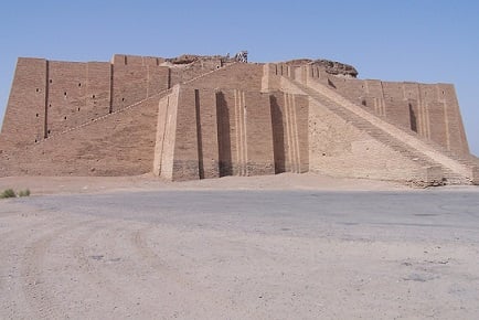 A beige, massive, step pyramid in the desert. It has huge ramps that connect the floor to the top.