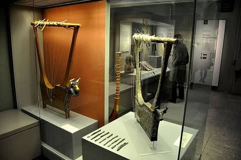Two large harps on display in a museum.