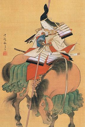 A woman riding a horse. She is wearing a samurai's armor and carrying weapons.