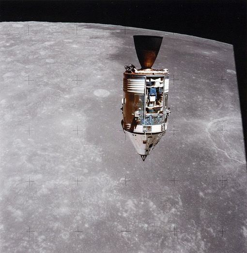 Space. A small rocket-like spaceship floats in space. In the background is the gray surface of the Moon.