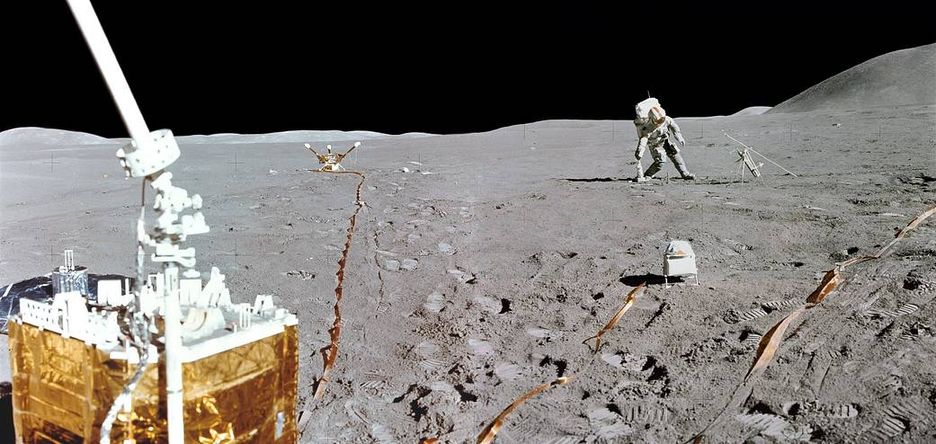 Lunar surface. A strange bright object is on the foreground, two smaller objects are in the background along with a fully suited astronaut.