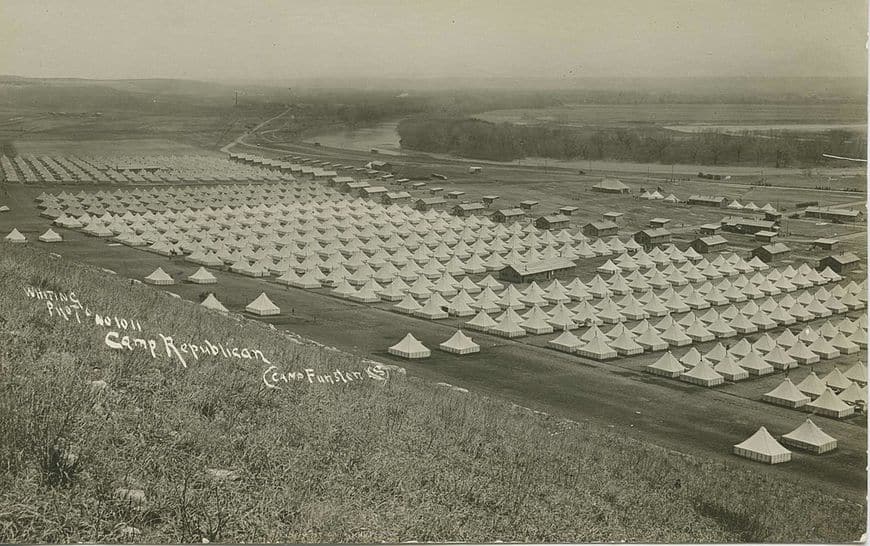 Panoramic view of a military camp with hundreds of tents.
