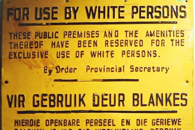 A sign which reads: "For use by white persons. These public premises and the amenities thereof have been reserved for the exclusive use of white persons. By order Provincial Secretary"The same message is repeated below in Afrikaans.