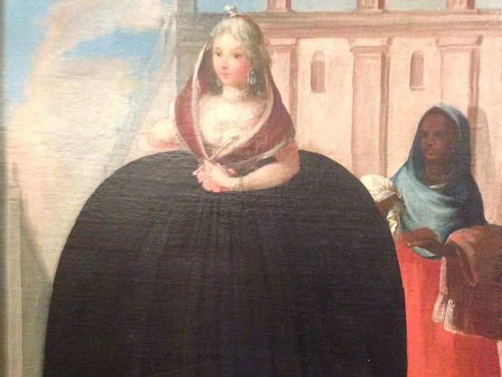 Painting. A white woman elegantly dressed is accompanied by a black woman that walks behind her.