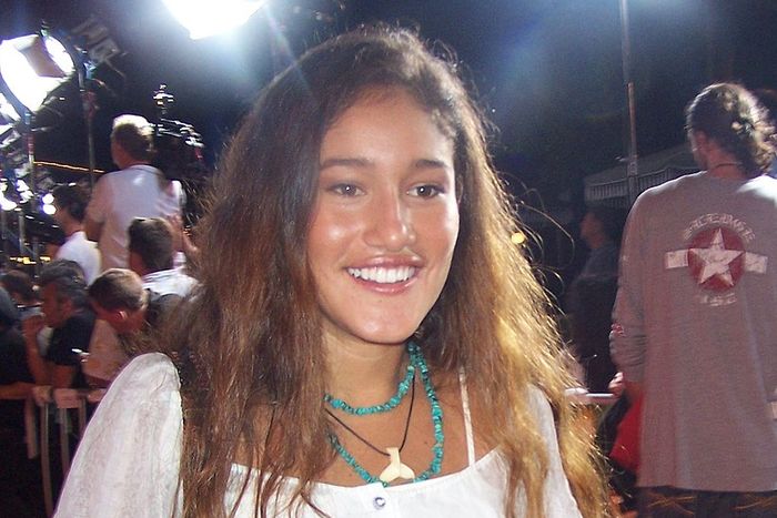 A young woman smiling on the red carpet
