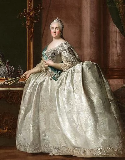 Full portrait. A middle-aged woman, she looks regal from afar. She wears a magnificent and big, shiny silver dress.
