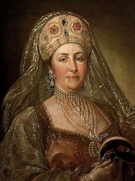 Catherine in her fifties or sixties wearing an intricate and very elegant dress with a headdress.