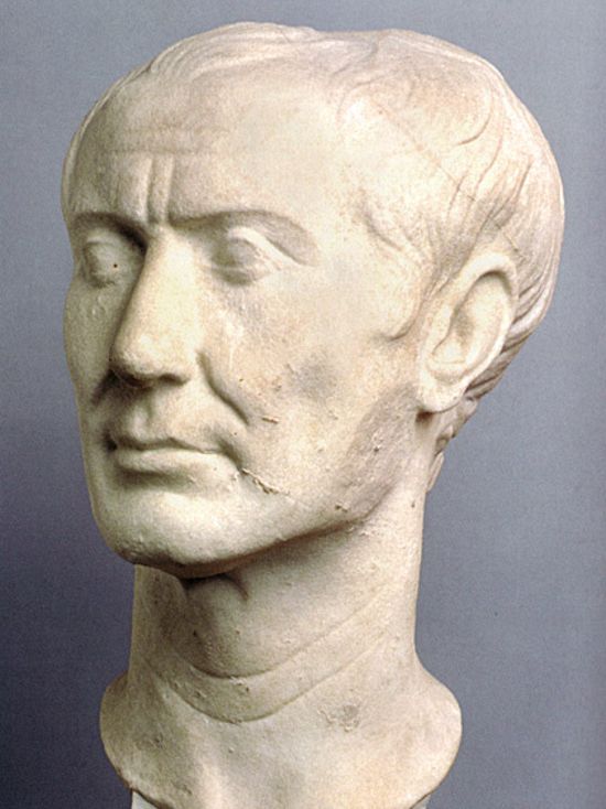Same bust from another angle. His face is thin, but not overly elongated. He has medium-sized eyes, his eyebrows are straight and defined but not bushy, he has high cheekbones, his ears rest on the sides of his head without protruding.