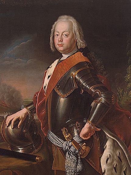 Portrait of a man in armour. He also wears a velvet cape and looks dignified.
