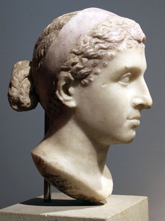 Same marble bust from the profile. She is pretty, with strong features.