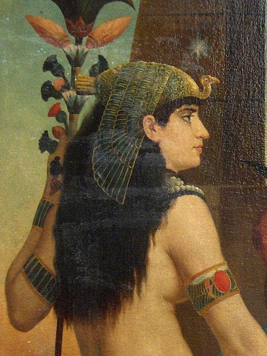 Oil painting showing a white woman, prhaps she is a bit tawny. Her facial features are very similar to the ones of the first drawing. She has long, black hair and wears a royal Egyptian headdress.